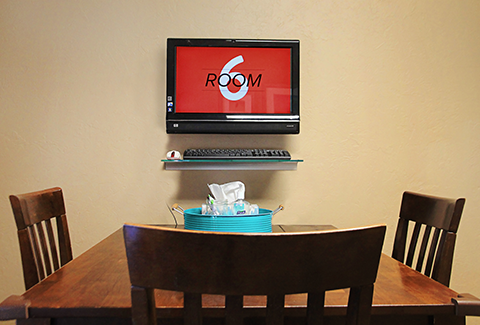 Meeting Room: Table and chairs with a TV